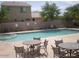 Community pool with jacuzzi, multiple tables and chairs for lounging near the sparkling, refreshing water at 21050 E Munoz St, Queen Creek, AZ 85142