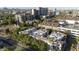 Aerial view of multi-story buildings with lush greenery with a city skyline in the background at 235 W Portland St, Phoenix, AZ 85003
