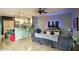 Spacious living room with hardwood floors, TV, and modern lighting fixtures at 235 W Portland St, Phoenix, AZ 85003