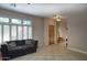 Inviting living room with plush couch, plantation shutters and tile flooring at 235 W Portland St, Phoenix, AZ 85003
