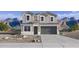 Charming two-story home featuring a gray exterior, gray roof, desert landscaping, and mountain views at 24205 W Southgate Ave, Buckeye, AZ 85326