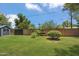 Private backyard featuring lush lawn, mature trees, and fenced perimeter at 2913 E Earll Dr, Phoenix, AZ 85016