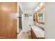 Bathroom features tile floors, single sink vanity, tub and shower at 2913 E Earll Dr, Phoenix, AZ 85016