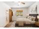 Bright bedroom featuring plush carpet, ceiling fan and a window view of the backyard at 2913 E Earll Dr, Phoenix, AZ 85016