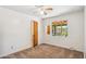 A bedroom with neutral carpet, a window overlooking the backyard, and a ceiling fan for added comfort at 2913 E Earll Dr, Phoenix, AZ 85016