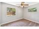 Empty bedroom with natural lighting, a ceiling fan, and two windows overlooking a backyard at 2913 E Earll Dr, Phoenix, AZ 85016