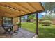 Relaxing covered patio with dining and view of storage shed and backyard at 2913 E Earll Dr, Phoenix, AZ 85016