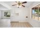 Bright dining area with tiled floors, ceiling fan, and built in white storage cabinets at 2913 E Earll Dr, Phoenix, AZ 85016