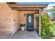 Close-up of a charming front door with decorative details and a potted plant on the porch at 2913 E Earll Dr, Phoenix, AZ 85016
