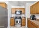Well-equipped kitchen with stainless steel oven, gas range, microwave and oak cabinets at 2913 E Earll Dr, Phoenix, AZ 85016