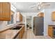 Modern kitchen with stainless steel appliances, tiled flooring, and oak cabinets at 2913 E Earll Dr, Phoenix, AZ 85016