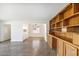 Bright living room featuring white walls, concrete floors, built-in cabinets, and natural light from a window at 2913 E Earll Dr, Phoenix, AZ 85016