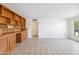 Spacious living room with tiled floors and built-in wooden shelving with storage at 2913 E Earll Dr, Phoenix, AZ 85016