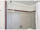Shower features tiled walls, chrome shower head, and neutral tone at 2913 E Earll Dr, Phoenix, AZ 85016