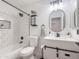 Beautiful bathroom with a modern white vanity, framed mirror, black hardware, and tiled shower/tub combo at 30517 N Maple Chase Dr, San Tan Valley, AZ 85143