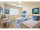 Charming bedroom with two beds, a desk, and bright, cheerful decor at 30517 N Maple Chase Dr, San Tan Valley, AZ 85143