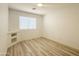 This empty bedroom is spacious with modern flooring and a window at 30517 N Maple Chase Dr, San Tan Valley, AZ 85143