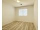 This empty bedroom is spacious with modern flooring and great light from a window at 30517 N Maple Chase Dr, San Tan Valley, AZ 85143
