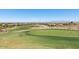 A close up of a green on a golf course in a residential community on a sunny day at 30517 N Maple Chase Dr, San Tan Valley, AZ 85143