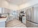 Modern kitchen with white cabinets, subway tile backsplash, stainless steel appliances, and recessed lighting at 30517 N Maple Chase Dr, San Tan Valley, AZ 85143