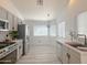 Kitchen area featuring stainless appliances, white cabinets, and tiled backsplash at 30517 N Maple Chase Dr, San Tan Valley, AZ 85143