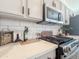 Modern kitchen features white cabinets, subway tile backsplash, and stainless steel appliances at 30517 N Maple Chase Dr, San Tan Valley, AZ 85143