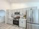 Well-lit kitchen with white cabinets, stainless steel appliances, and an open layout at 30517 N Maple Chase Dr, San Tan Valley, AZ 85143