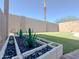 Beautifully landscaped backyard featuring vibrant plants, artificial turf, and decorative gravel at 30517 N Maple Chase Dr, San Tan Valley, AZ 85143