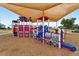 Neighborhood playground showcasing a train-themed play structure with a shade structure at 30517 N Maple Chase Dr, San Tan Valley, AZ 85143
