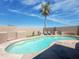 Sparkling pool with palm tree and lounge chairs, surrounded by privacy fence for backyard relaxation at 30517 N Maple Chase Dr, San Tan Valley, AZ 85143