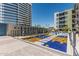 Well-manicured amenity deck with walking paths and cacti gardens between modern buildings at 3131 N Central Ave # 7004, Phoenix, AZ 85012