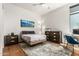 Cozy bedroom with a comfortable bed, wooden floors, and a bright window, offering a serene retreat at 3131 N Central Ave # 7004, Phoenix, AZ 85012