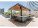 Outdoor kitchen with multiple grills, bar seating, and a pergola for comfortable hosting at 3131 N Central Ave # 7004, Phoenix, AZ 85012