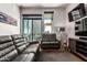 Living room with large windows, comfortable sofas, and a modern entertainment setup at 3131 N Central Ave # 7004, Phoenix, AZ 85012