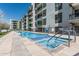 Resort-style community pool and spa with handicap accessibility features, set against modern building at 3131 N Central Ave # 7004, Phoenix, AZ 85012