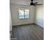 Bright bedroom features wood-look floors and a window view of the backyard pool at 3421 W Montecito Ave, Phoenix, AZ 85017