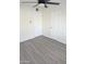 This bedroom has gray wood-look floors, white walls, and two white doors at 3421 W Montecito Ave, Phoenix, AZ 85017