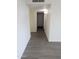 Long hallway featuring grey wood-look floors and white walls at 3421 W Montecito Ave, Phoenix, AZ 85017