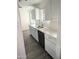 Bright kitchen featuring white cabinets, stainless steel sink, and modern countertops at 3421 W Montecito Ave, Phoenix, AZ 85017