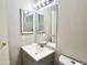 Neutral bathroom featuring a vanity with gray cabinets, mirror, and fixtures at 3511 E Baseline Rd # 1098, Phoenix, AZ 85042