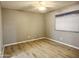 A well-lit bedroom with wood-look floors and a ceiling fan offers a neutral color palette at 3511 E Baseline Rd # 1098, Phoenix, AZ 85042