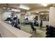 Well-equipped gym with cardio machines, weights, mirrored walls, and ceiling fans for comfortable workouts at 3511 E Baseline Rd # 1098, Phoenix, AZ 85042