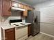 This kitchen features stainless steel refrigerator, an electric range, and abundant cabinet space at 3511 E Baseline Rd # 1098, Phoenix, AZ 85042