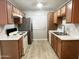 This kitchen features stainless steel refrigerator, an electric range, double sinks, and abundant cabinet space at 3511 E Baseline Rd # 1098, Phoenix, AZ 85042