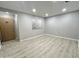 Inviting living space with light wood laminate flooring, fresh gray paint, and a window at 3511 E Baseline Rd # 1098, Phoenix, AZ 85042