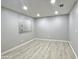 Inviting living space with light wood laminate flooring, fresh gray paint, and a window at 3511 E Baseline Rd # 1098, Phoenix, AZ 85042