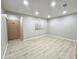 Inviting living space with light wood laminate flooring, fresh gray paint, and a window at 3511 E Baseline Rd # 1098, Phoenix, AZ 85042
