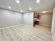 Spacious living area featuring light wood laminate flooring, fresh gray paint, and recessed lights at 3511 E Baseline Rd # 1098, Phoenix, AZ 85042