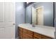 Bathroom featuring wood cabinets, white countertops, and a large mirror at 3531 E Norwood Cir, Mesa, AZ 85213