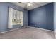Blue bedroom with carpet flooring, window shutters, and a ceiling fan at 3531 E Norwood Cir, Mesa, AZ 85213
